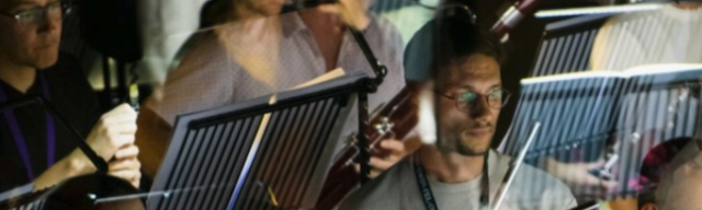 A group of musicians with music stands.